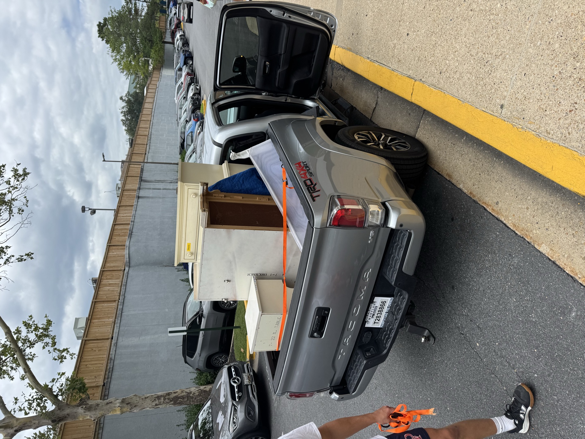 MOCO Junk Bros crew loading a mattress and boxes onto the trailer