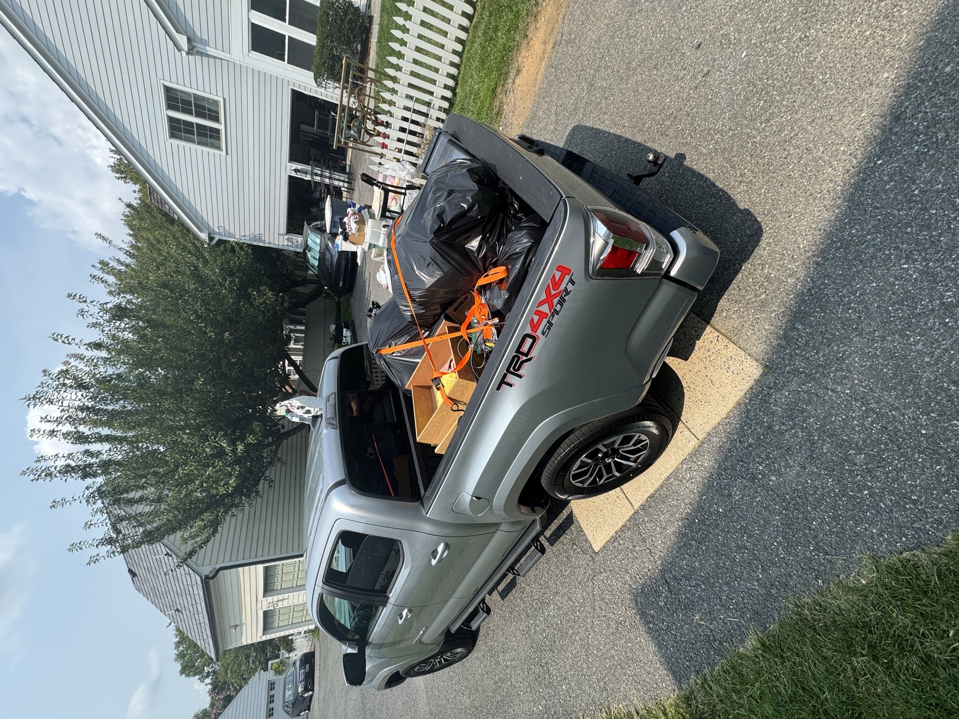 Trailer loaded with a mattress and furniture during a residential cleanout