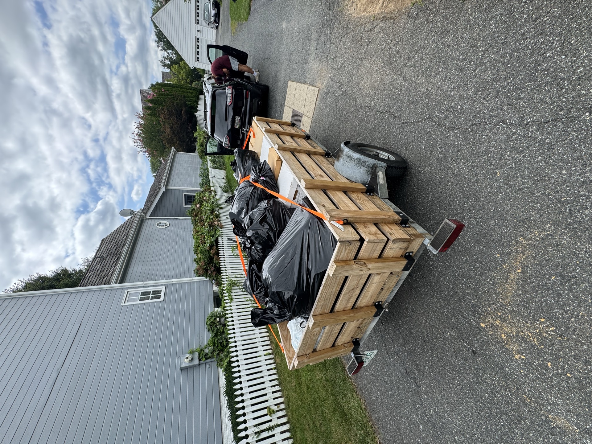 Trailer loaded with a mattress and boxes for a cleanout job