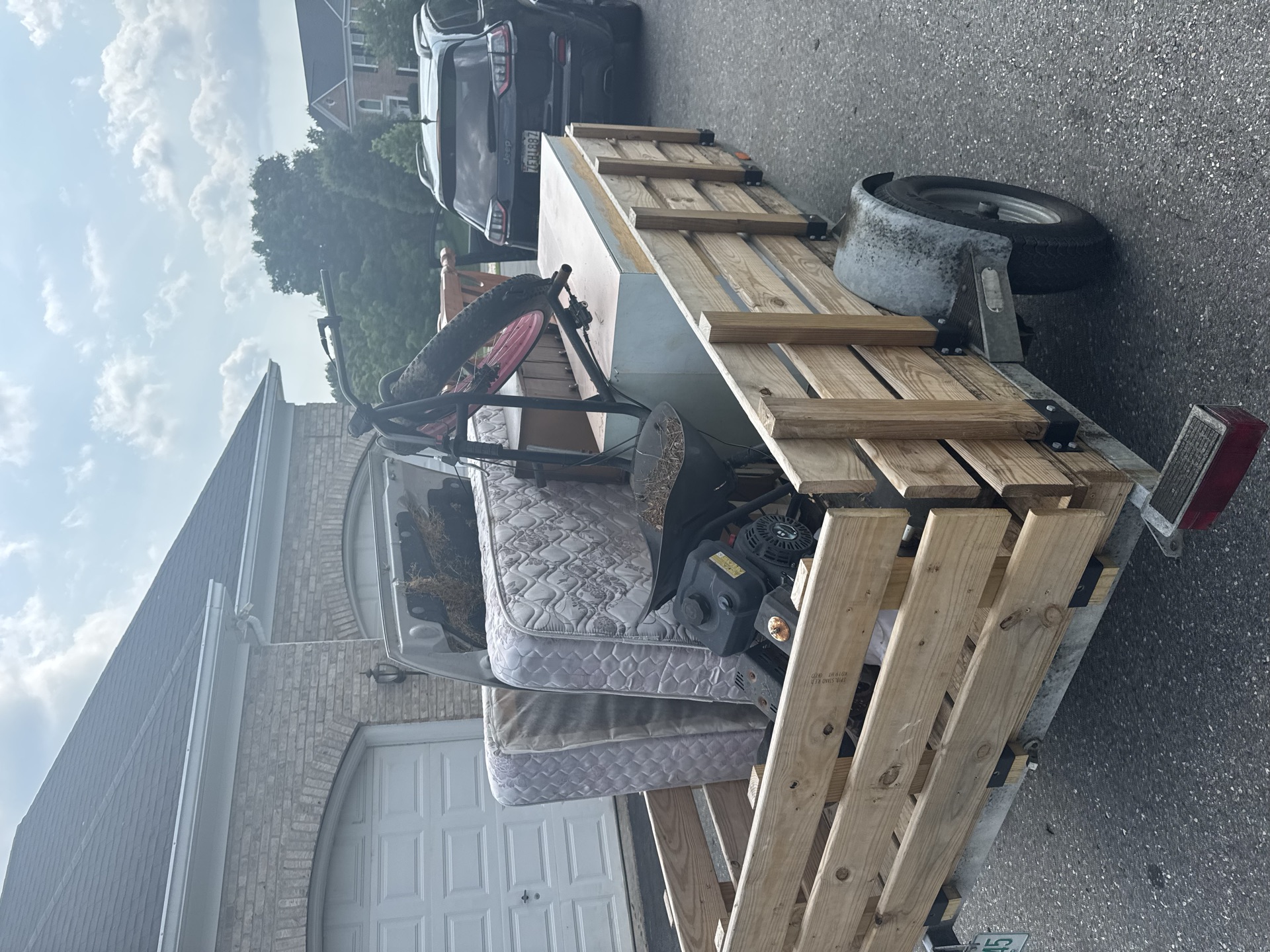 Trailer loaded with a mattress and furniture during a residential job