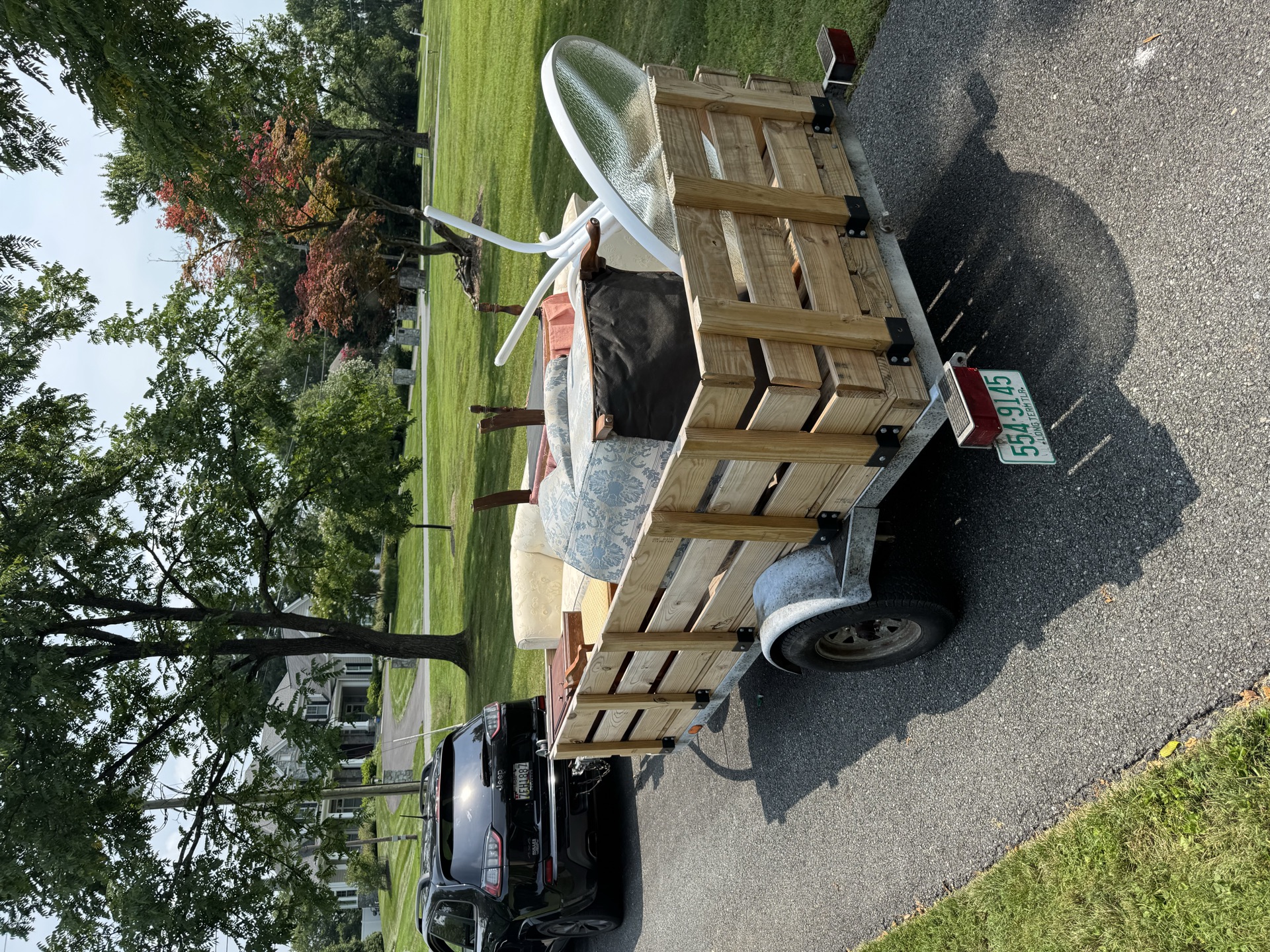 Trailer loaded with patio and wicker furniture for haul away