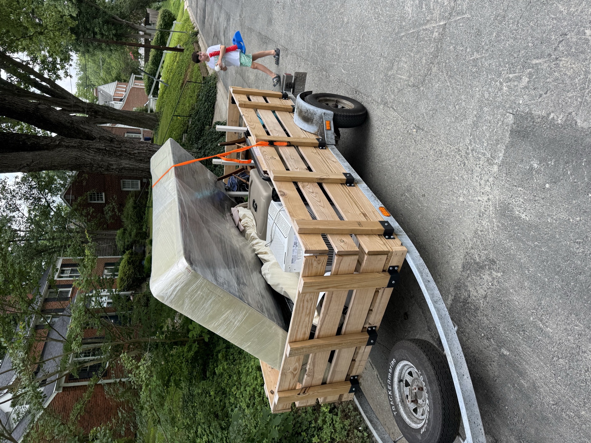 Trailer loaded with a mattress and box spring for a residential cleanout