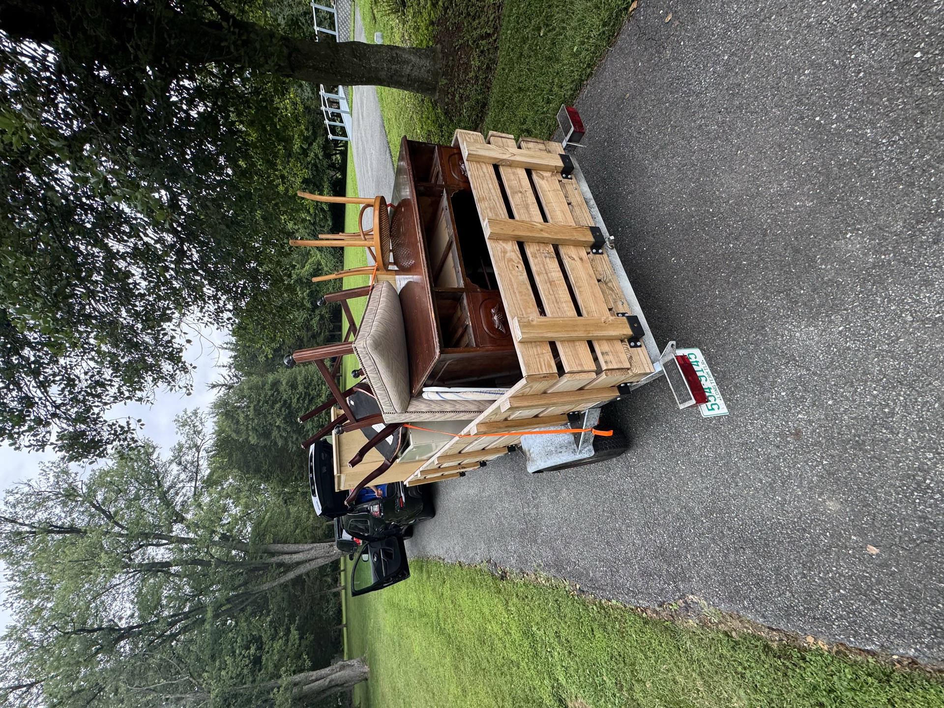 Trailer loaded with chairs and a dresser for furniture removal