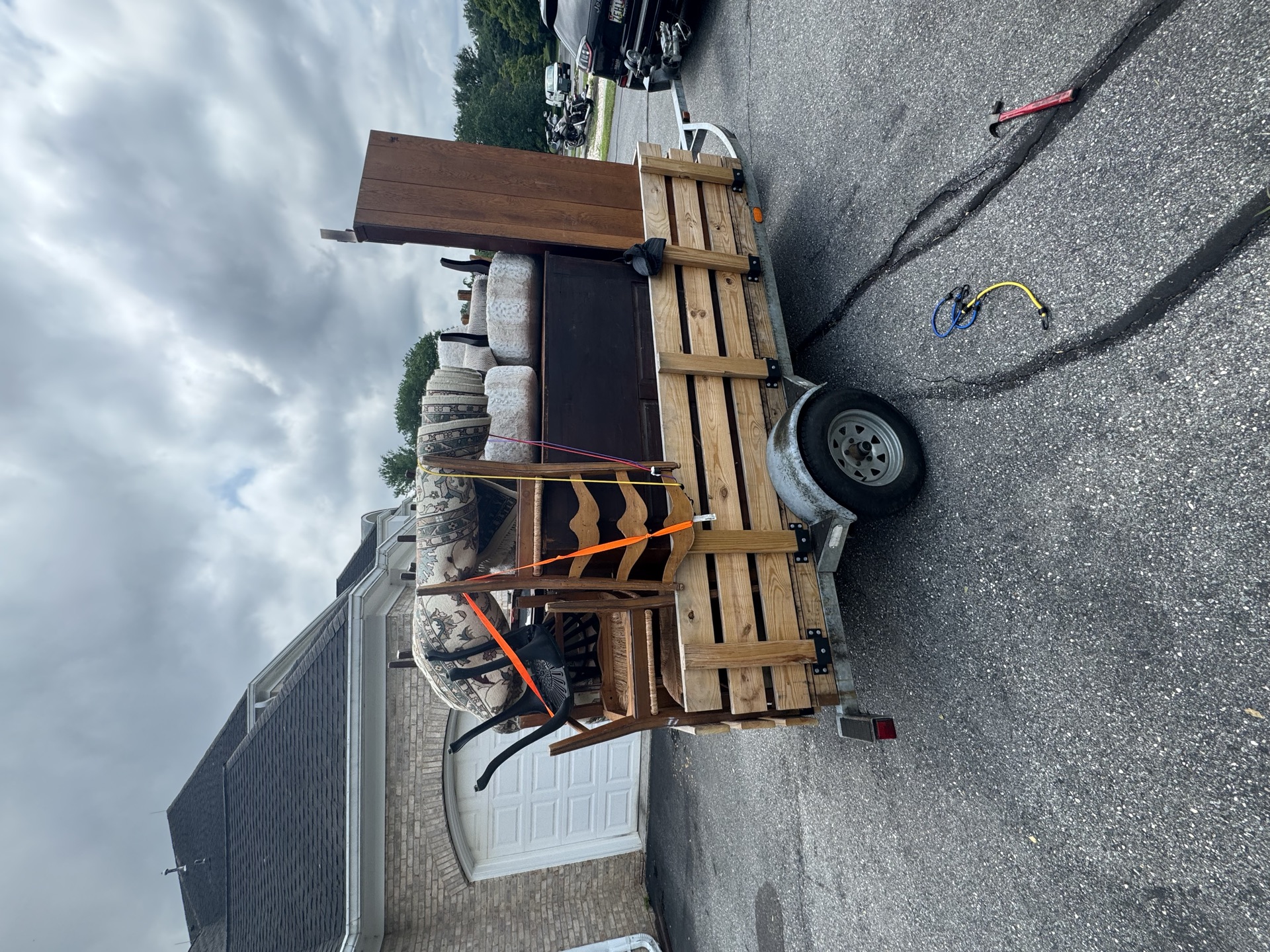 Trailer loaded with a rocking chair and dresser for a furniture pickup