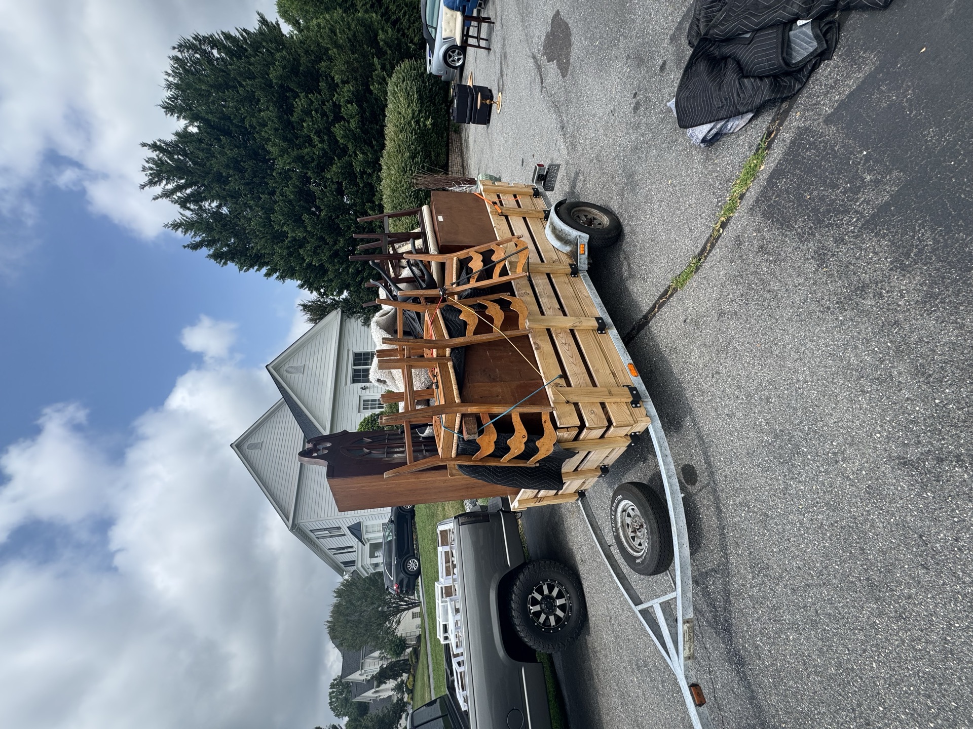 Trailer loaded with a dresser and headboard for furniture removal