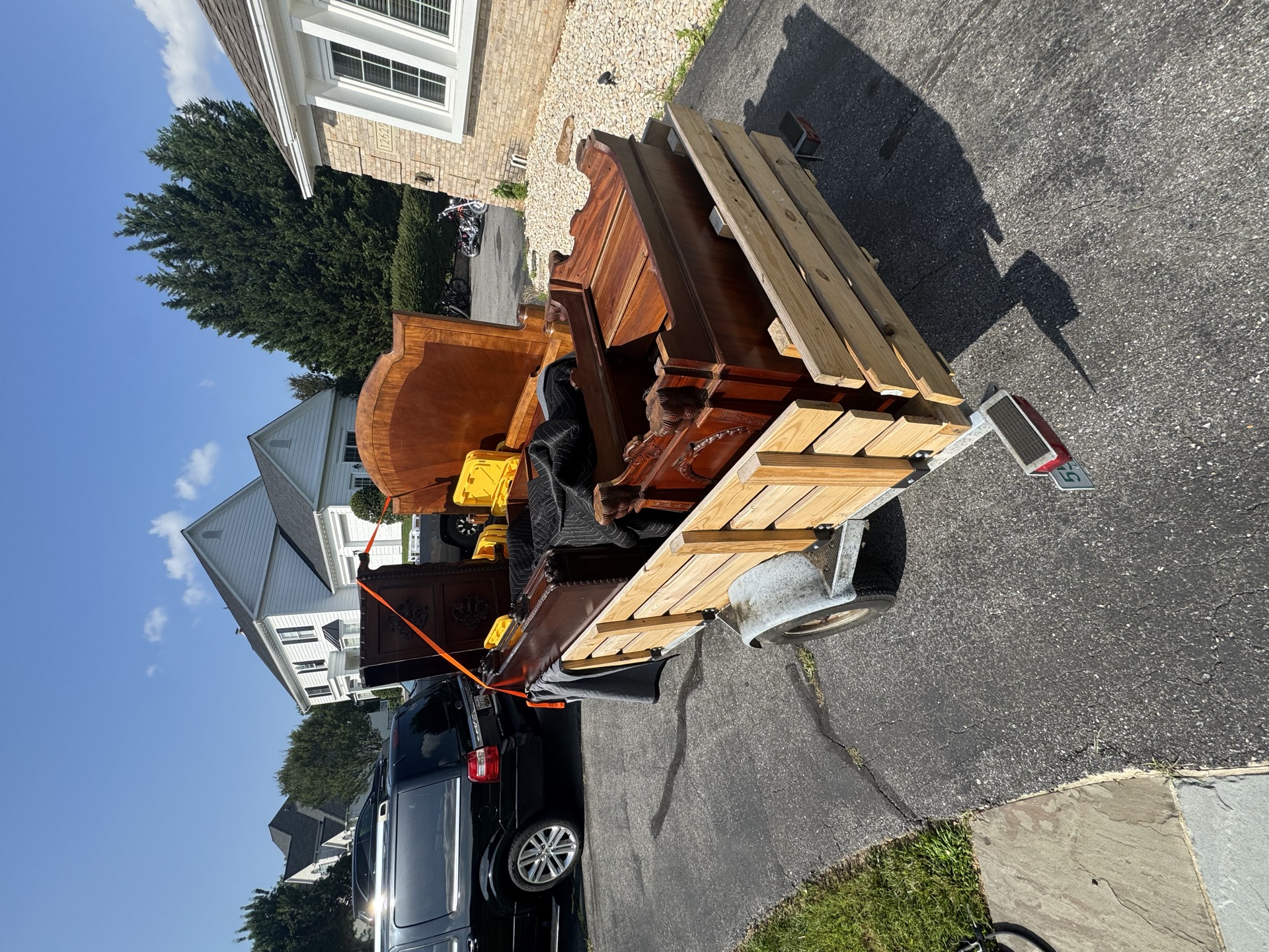 Trailer loaded with a cabinet and tools for a cleanout job