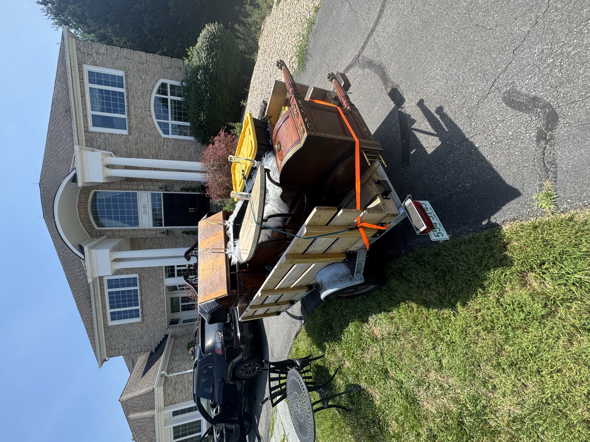 Trailer loaded with construction and wood debris on a suburban street