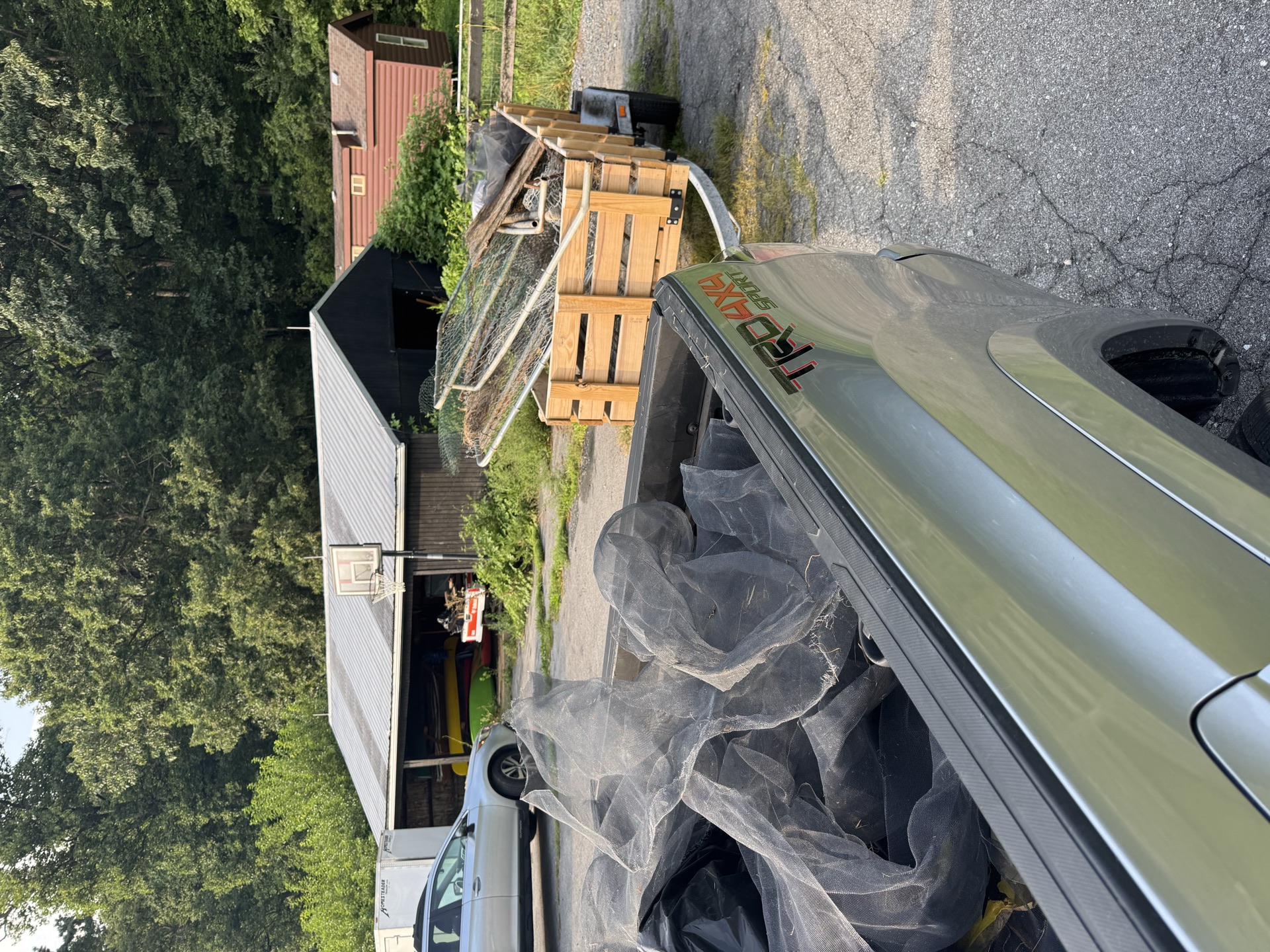 Truck bed loaded with tarps and debris, trailer haul-away job
