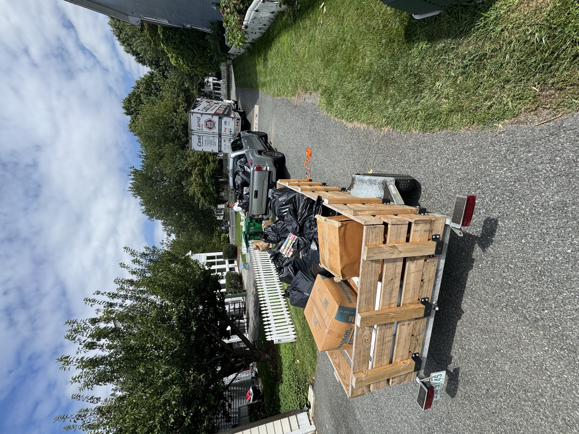 Truck bed loaded with yard waste and debris